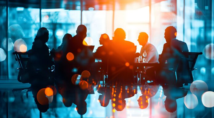 Abstract representation of a dynamic business meeting with city reflections. Copyright: Rax Qiu - stock.adobe.com