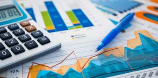 Financial charts showing trends, a calculator, and a blue pen. Perfect for money and financial stock photos. Copyright: Mark - stock.adobe.com