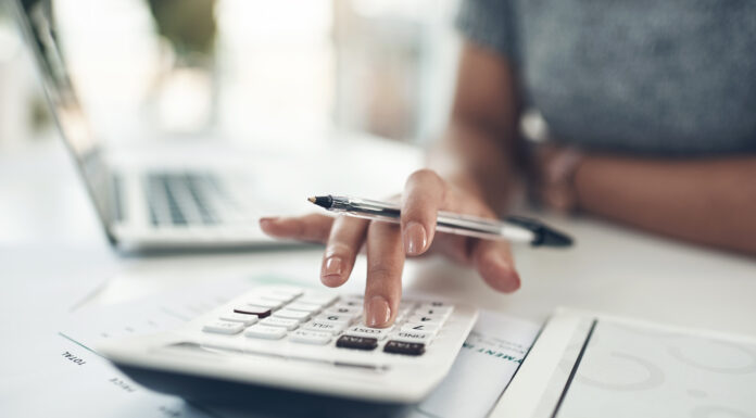 Finance planning, budget or savings manager calculating expenses, taxes or company profits with laptop, paperwork or calculator. Closeup hands of female financial leader checking office staff ... Copyright: N Felix/peopleimages.com - stock.adobe.com