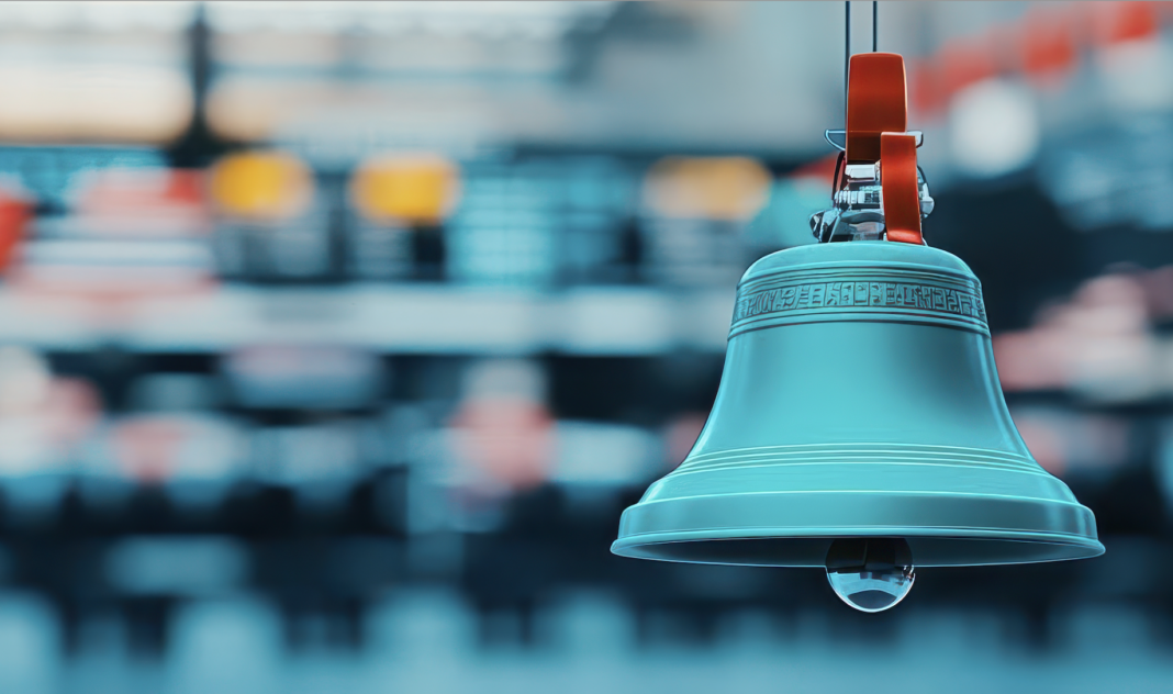 A photo image of a traditional stock market bell symbolizing the opening or closing of a trading day on a busy stock exchange floor. Copyright: taweesak - stock.adobe.com