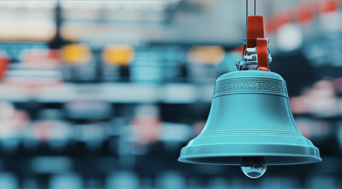 A photo image of a traditional stock market bell symbolizing the opening or closing of a trading day on a busy stock exchange floor. Copyright: taweesak - stock.adobe.com