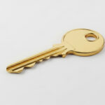 Symbolbild. Shiny golden key on a white background, symbolizing success, new opportunities, and important decisions. Copyright: Helena - stock.adobe.com