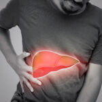 Symbolbild. The illustration of liver is on the man's body against gray background. A men with hepatitis and fatty liver problem. Copyright: eddows - stock.adobe.com