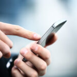 Symbolbild. Close up of a man using mobile smart phone. Copyright: PhotoStar - stock.adobe.com
