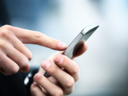 Symbolbild. Close up of a man using mobile smart phone. Copyright: PhotoStar - stock.adobe.com
