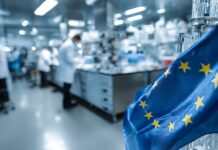 Der Biotech Act: Neue Dynamik für Kapital, Innovation und Wachstum Symbolbild. European Union flag waving in modern laboratory with scientists conducting research, symbolizing innovation and collaborative science across the EU. Copyright: Farah - stock.adobe.com