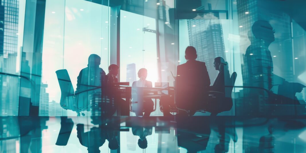 Business professionals engaged in a collaborative discussion during a conference meeting in a modern office setting