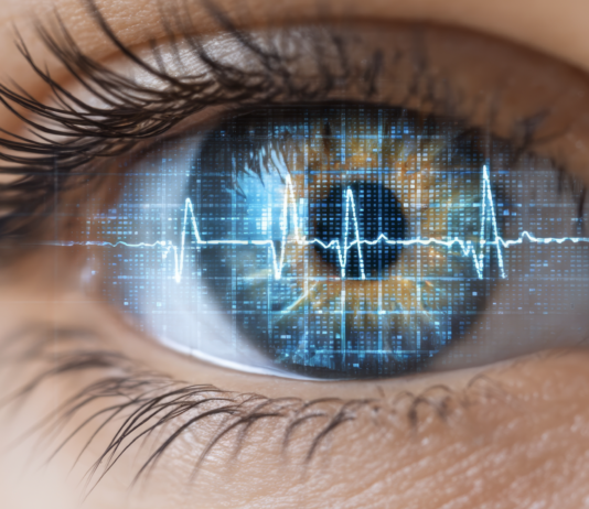 „Gesund durch Pharma, Ernährung und Digitale Therapien“ Symbolbild. Close up human eye with digital heartbeat reflection, technology and health concept, futuristic blue interface, innovation, vision, and biometric security. Copyright: Yuparet - stock.adobe.com