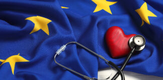Stethoscope, red heart and flag of European Union on white wooden table. Copyright: New Africa - stock.adobe.com